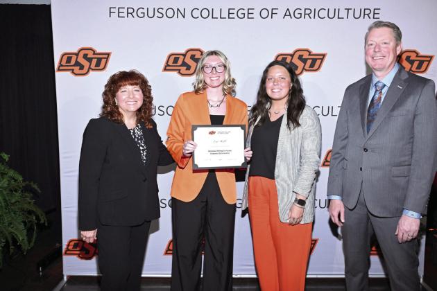 Cynda Clary, associate dean for academic programs and Jayson Lusk, dean for the Ferguson College of Agriculture, present Eva Webb with a scholarship Photo provided by OSU