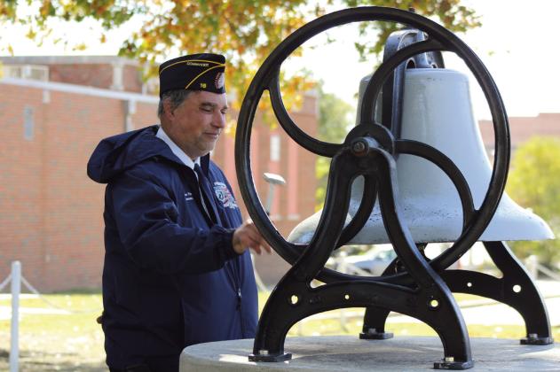American Legion Gill-Mattox Post 16 Commander Keith DiPatri rings the Navy bell 11 times to start the Veterans Day Program, hosted by the Shawnee Veterans Memorial Committee at Woodland Veterans Park on Nov. 11. DiPatri also spoke about his time in the Air Force during the event. Natasha Dunagan, Countywide &amp; Sun
