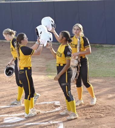 Tecumseh senior Jessi Hull clacks helmets with her teammates after hitting a home run during Spring Showdown. Photo courtesy of Kenetta Lisenbee