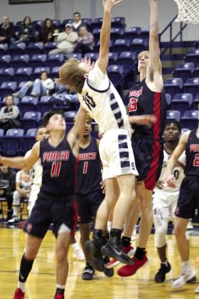 Shawnee’s Trenton Needham sinks a shot in the third quarter of the home game.