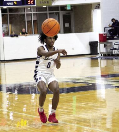 Shawnee’s Daytain Patton passes the ball in the fourth quarter of the home game against Ponca City on Dec. 16. The Wolves won 43-42, after trailing most of the game. The Lady Wolves lost their game with Ponca City, 36-41.