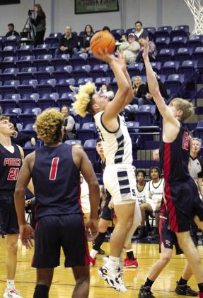 Shawnee’s J.J. McClain goes in for a basket and is fouled in the third quarter of the home game against Ponca City.