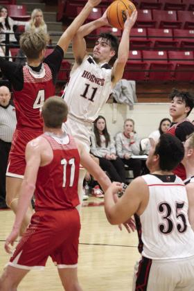 Macomb senior Cameron Richardson aims for the bucket in the second quarter of the Class B Regional game with Maysville.