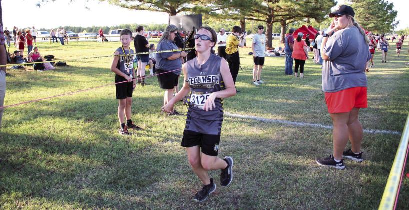 Tecumseh freshman Harper Stone runs across the finish line in 10th place during the Tecumseh Cross Country Meet on Sept. 22. Both North Rock Creek freshmen, Kadence Munn came in third with a time of 7:02.45, and Abby Bloyed placed ninth. The Tecumseh Girls Team placed sixth, and the NRC Girls Team ranked fourth out of several area schools.