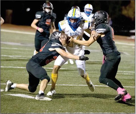 Bethel senior Zac Roybal gets trapped by two Crossings Christian defenders during the away game on Oct. 21. Bethel lost 0-35. Photo provided by Richelle Treece.