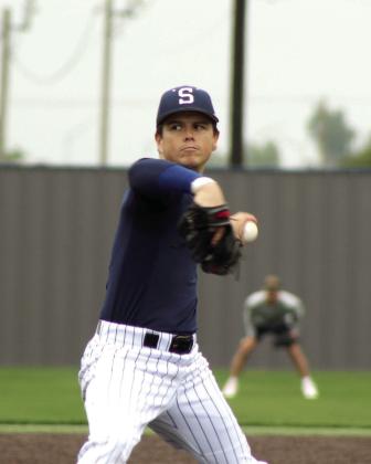 Shawnee Alum Eli Davis winds up during the Shawnee High School Alumni Game on April 25. Davis played for the Kansas Jayhawks and the Oklahoma City Stars, as well as the Milwaukee Milkmen.