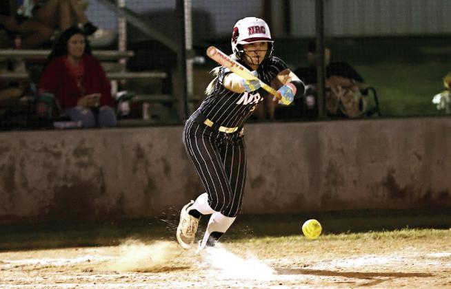 Aubree Shivelhood bunts for North Rock Creek in the McLoud softball tournament.