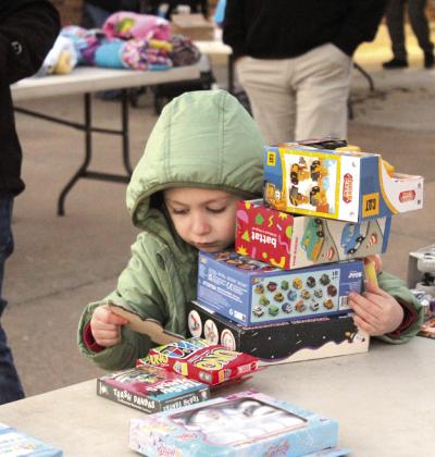 Greyson Diaz, 5, found a stack of gifts during the Fourth Annual Shawnee Police Department Toy Drive on Dec. 18.