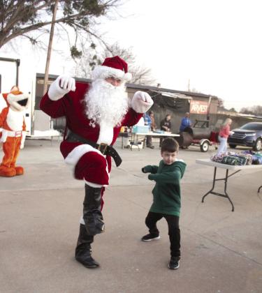 Santa Claus strikes a pose with Tobias Diedrich, 7, during the Fourth Annual Shawnee Police Department Toy Drive on Dec. 18. Photos by Natasha Dunagan, Countywide &amp;amp; Sun