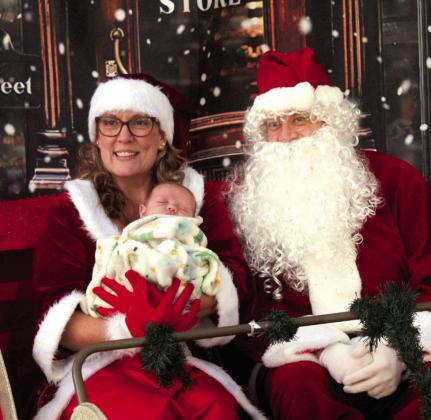 Santa and Mrs. Claus pose with a seven-week-old baby, the youngest of the 200 children who received presents at the Fourth Annual Shawnee Police Department Toy Drive on Dec. 18.