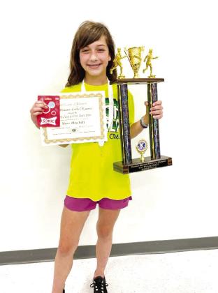 Fifth-grader Bree Mitchell, of South Rock Creek, poses with her Golden Trackshoe trophy and certificate after winning three Division II events in Kiwanis Little Olympics on May 12. Photo provided.