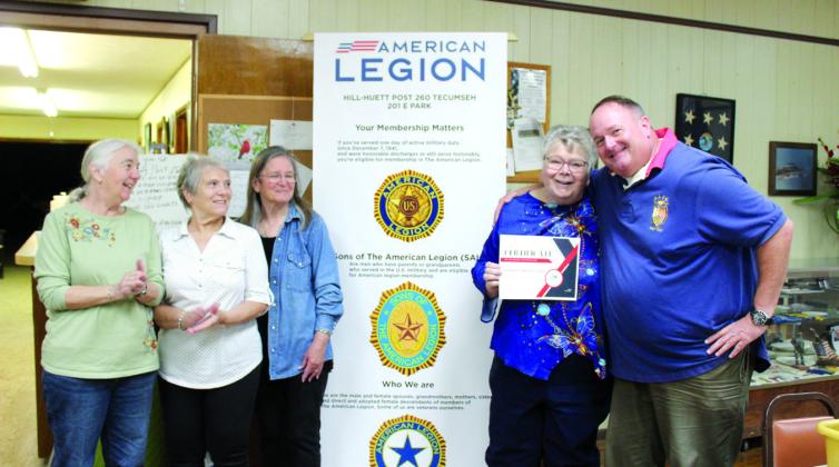 Norman Veterans Center Recreation Coordinator Darold Lairson, far right, presents American Legion Post #260 Auxiliary President Donna Snodgrass with a belated certificate for Volunteer Appreciation Week on May 8. The Tecumseh American Legion Auxiliary members have hosted the Norman veterans for bingo each month for at least 30 years, said Lairson.