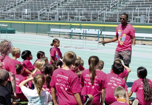 Former track star and sixth world's fastest man, Charles Clark, speaks with children at the Health Week Track Clinic, held at Oklahoma Baptist University on May 28. Students were divided into first- through sixth-graders and seventh-graders to seniors, said Macy Muirhead with POGO. Health Week was sponsored by Avedis Foundation, Pottawatomie Go (POGO), the YMCA, Community Renewal, City of Shawnee Parks &amp; Recreation, Pioneer Library System and Andrea Beck.