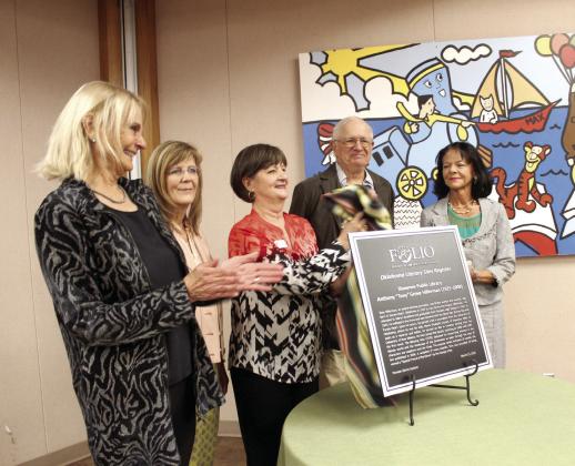 A new Oklahoma Literary Sites Register plaque for the late author Tony Hillerman is unveiled during a dedication ceremony at Shawnee Public Library on March 15 in celebration of the 100th anniversary of his birth year. Shown, from left, are Anne Hillerman, author and daughter of Hillerman; Lisa Wells, Pioneer Library Systems Director; Mary Sims, Shawnee library branch manager; Dr. Bill Hagen, Emeritus Professor of English at OBU; and, Angie Lewis, President of Friends of Libraries in Oklahoma.