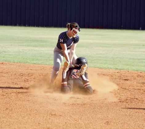 Asher senior Makaylee Harrell tries to tag a Carney runner as she dives into second base in the first inning of the Aug. 20 home game.