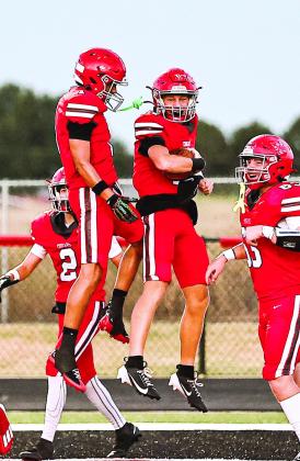 NRC's Cooper Standlee celebrates with Lance Carter after he scores a touchdown.