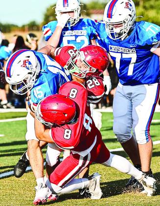 NRC's Holt Holland and Brodie Sherril make the tackle against OCA on Aug. 20 when the North Rock Creek football team held a 4-way scrimmage against Bethel, Henryetta, and OCA. NRC will host Tecumseh in the season opener on Aug. 28.