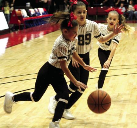 Sparklers Dance Team members Bristol Lane, 8, of Prague; Eli Osborne, 9, of Dale; and Taiyn Masoner, 7, of Tecumseh, get in a quick game during halftime of the Potawatomi Fire home game on March 25. Two of their mothers, Lindsay Lane and Audrey Masoner, won a metal cooler in the “Knockout” contest at halftime. Countywide &amp; Sun/Natasha Dunagan