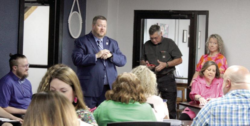 New Shawnee Public Schools Superintendent Dr. Jason James speaks with a room full of faculty and staff during the meet-and-greet held after the SPS Board of Education Special Session in which he was hired on April 22. Board President Clif Harden said James will begin consulting on April 24, and his contract will begin on June 2. Natasha Dunagan, Countywide &amp; Sun