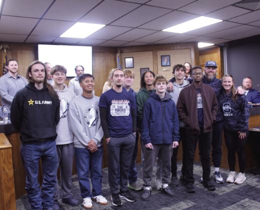 The Shawnee High School Cross Country team was recognized for competing at the state competition, during the Dec. 15 Shawnee Board of Education meeting. From left, they are Ayden Ringwald, Jack Timmons, Kain Nenaikita, Conner Brantley, Colby Jones, Joseph Bevel, Booker Dahlman, Emersen Byers, Izayiah New, Coach Bobby Licklider. and Coach Jaylin Stapleton. Natasha Dunagan, Countywide &amp; Sun