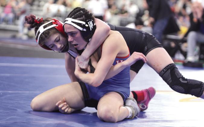 McLoud's Remy Whitney prepares to flip her Harrah opponent during the State Wrestling Tournament Finals, held at the OG&amp;amp;E Coliseum at the Oklahoma State Fairgrounds on Feb. 28. Whitney won her 100 weight class, and the McLoud Girls Wrestling Team won first with 146 points for the second straight year.