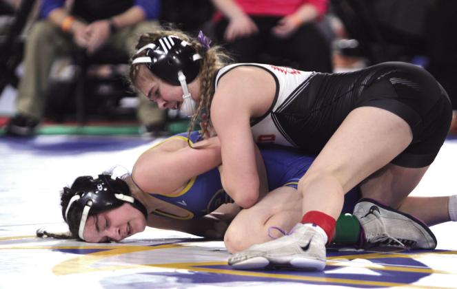 McLoud's Carli Sisco works to pin her opponent before winning in the 105 weight class.