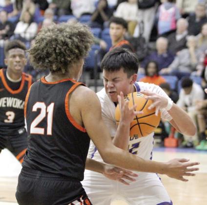 Bethel sophomore Ryder Davenport guards the ball as he makes his way to the hoop during the Jan. 30 home game with Wewoka. The Wildcats lost a hard-fought game, ending at 53-56 in overtime. Countywide &amp; Sun/Natasha Dunagan