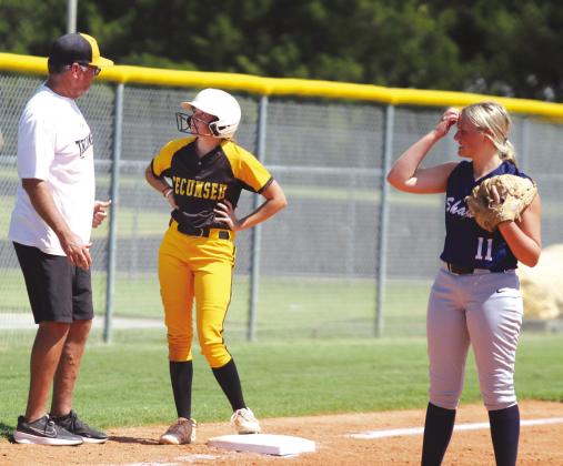 Tecumseh Head Fast-Pitch Coach Chad Trahan talks with sophomore Madison Gray after she hit a triple, as Shawnee’s Karma Mason looks on, during the Dale-Tecumseh Tournament game on Sept. 5. The Lady Wolves lost to the Lady Savages, 10-0. Tecumseh won four out of their five games, and Shawnee won two. Dale won the tourney with no losses. Countywide &amp; Sun/Natasha Dunagan