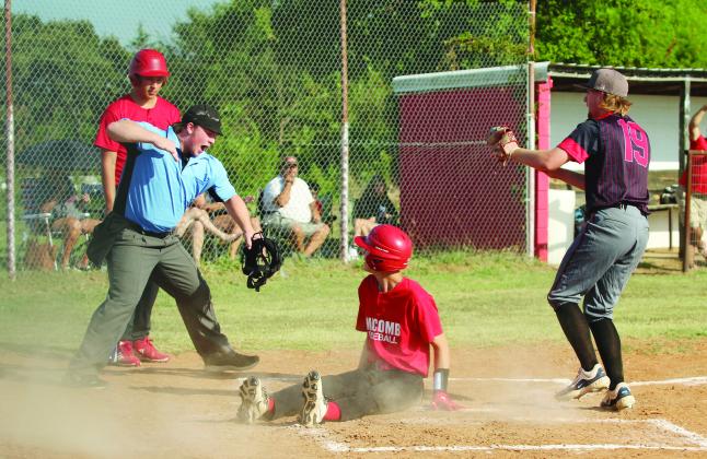 Macomb senior Connor Hutchinson slides in to steal home but is declared out by the umpire after Earlsboro senior, pitcher Jon Wilkins (#19), ran up for the tag during the baseball game at Macomb on Aug. 14. The Earlsboro Wildcats won, 18-0.