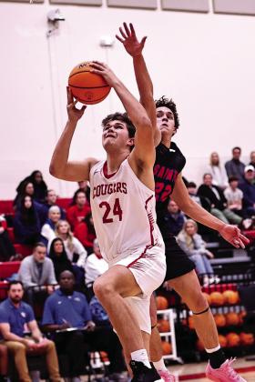 North Rock Creek’s Jace Plumb goes around the OCS defender for the layup.