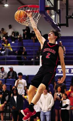 North Rock Creek’s Kohen Warden makes the first dunk of the game. The Cougars beat the Wildcats 48-20. Photo courtesy of Gowin Photography