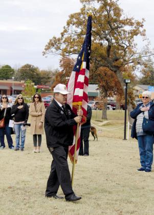Don Plumley, with the Shawnee Veterans of Foreign Wars, walks up to post the colors during the Shawnee Veterans Day Program at Woodland Veterans Memorial Park on Nov. 11.