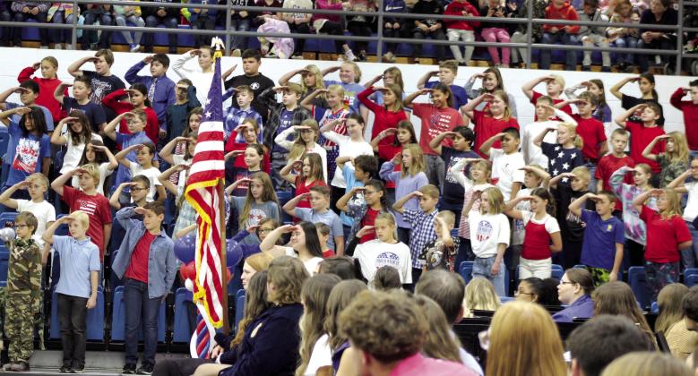 The Bethel fourth-grade students salute those veterans in attendance at the Bethel High School Veterans Program, after having sung “Those Who Serve” and “Proud of Our Veterans,” on Nov. 10 at the newly remodeled gym. They were led by music teacher Jessica Bourlon.