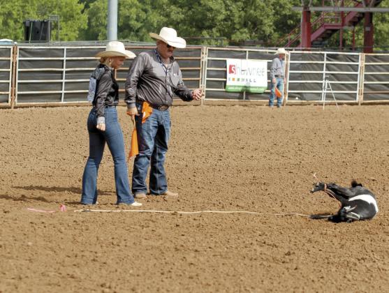 Rianne Tinsley of Shawnee watches the goat she had just tied in the IFYR on July 7. Goats must stay bound for six seconds after the contestant walks away.