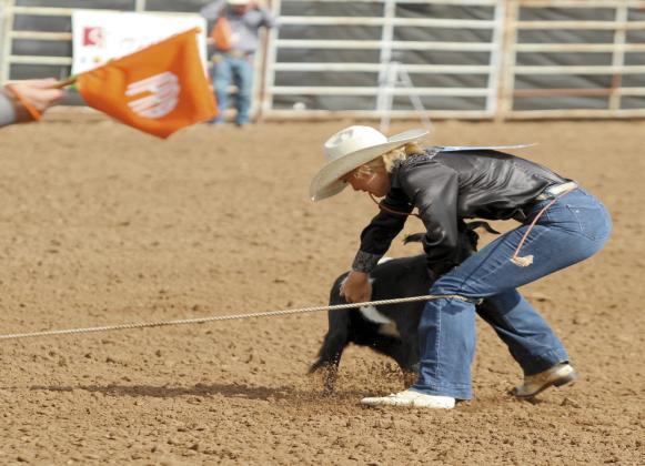 Bethel junior Rianne Tinsley grabs her goat to flip it over and tie the feet in the IFYR on July 7. Tinsley recently competed in the National High School Finals Rodeo in Rock Springs, WY, as the Oklahoma High School Rodeo Association Reserve Goat Tying Champion.