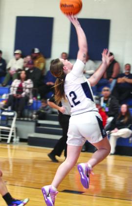 Asher's Makaylee Harrell takes the ball to the basket during the Jan. 3 home game against Konawa.