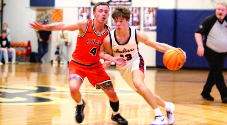 Asher's Pierce Aduddell pushes past the Konawa defense on his way to the hoop in the Sat., Jan. 3, home game. The Indians won 58-47.
