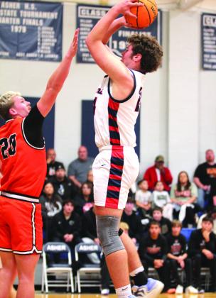 Asher's Greyson Wood aims and sinks a basket in the Sat., Jan. 3, home game against Konawa.