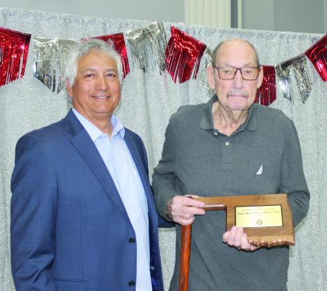 Former, long-time Asher baseball coach Murl Bowen, right, receives the first Asher Baseball Booster Club Hall of Fame plaque from current Head Baseball Coach David Rolette during the First Annual Asher Baseball Spring Kickoff and Hall of Fame Banquet at Asher Public Schools cafeteria on March 8. Nine other alumni were also inducted into the Hall of Fame. Natasha Dunagan, Countywide &amp; Sun