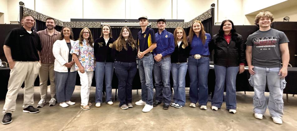The Tecumseh School Board poses with students honored at the April meeting. Shown, from left, are unknown, Dylan Hayes, Nicole Sanchez, Iva Bingham, Rayleigh Hopkins, Olivia Rawlins, Landyn Seaton, Blake Wright, Kimberly Holland, Channing Goodson, Maci Peacock and Malachi Deatherage. Photos by Julie Talton, Countywide &amp; Sun