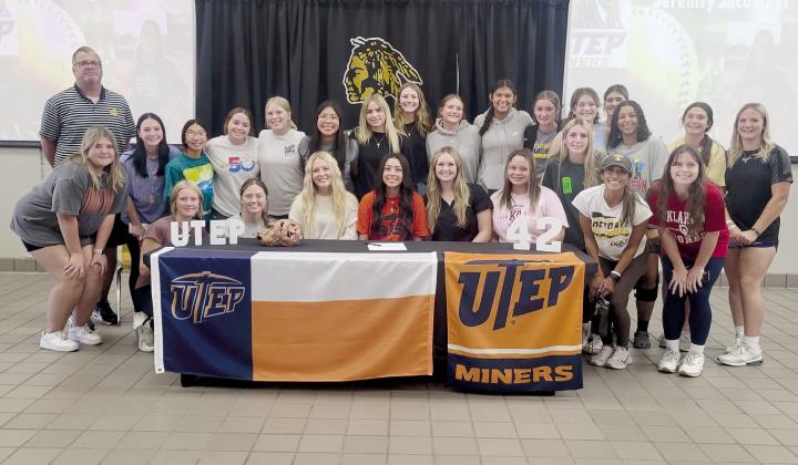 Tecumseh senior Serenity Jacoway, seated fourth from left, poses with the THS softball team and Tecumseh Head Fastpitch Coach Chad Trahan and Coach Kayla Rodriguez. Jacoway signed for softball with the University of Texas at El Paso on Nov. 8. Photo provided by Tracey Forrester.