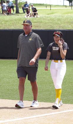 Tecumseh 2024 graduate Serenity Jacoway and Fast Pitch Coach Chad Trahan walk onto the field at the All-State Game held Saturday, June. 8. Photos by Kent Bush.