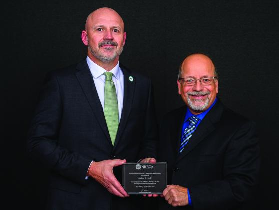 Pictured above is (left) Josh Holt with Gary Pfann, Director, Executive and Staff Education, National Rural Electric Cooperative Association. Photo provided