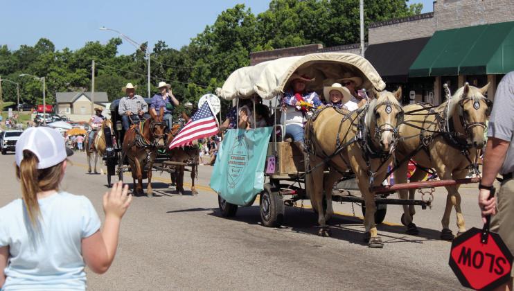 A covered wagon and carriage from Crossroads Cowboy Church in Harrah make their way east on Broadway Ave. during the McLoud Blackberry Festival Parade on June 21, 2025. File photo