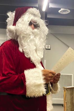 Victor Cope, dressed as Santa Claus this month, made his continuing plea the board to remove the “Savage” name. This month, he read about a dark chapter at Christmastime. Countywide &amp;amp; Sun/Julie Talton