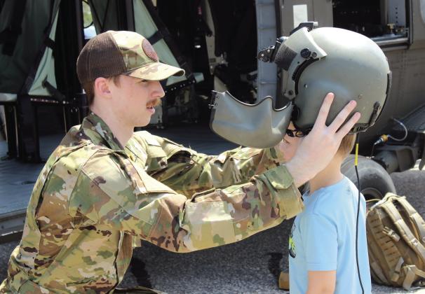 File photo In from of his Black Hawk helicopter, Sgt. Justin Donwerth places his helmet on Kaysen Meece, 4, of Texas, during Cops N' Kids on Aug. 23, 2025. The Sikorsky UH-60 Black Hawk will return this year, along with a few other helicopters, on Aug. 22.