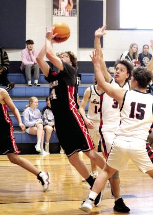 Macomb’s Trevor Laughery goes in for a basket but is fouled in the first quarter of the game at Asher on Jan. 28. The Asher Indians won, 50-14.