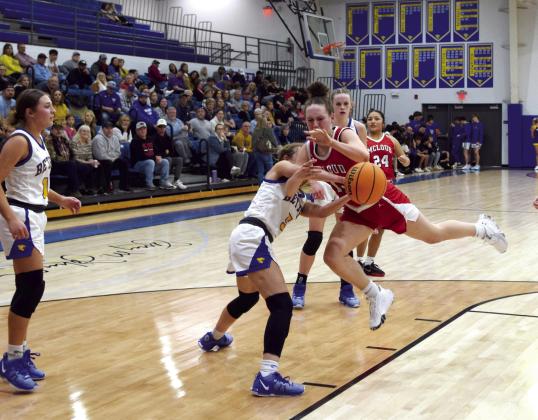 Creighton Conley tries to pass the ball as Brooklyn Duff pushes it away during the matchup between McLoud and Bethel on Feb. 2nd. The Lady Redskins lost 35-55.
