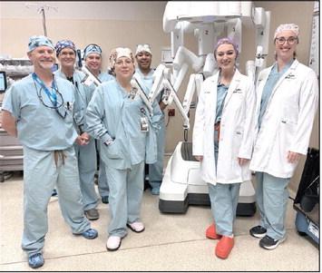 Robot Team in Shawnee: Dr. Amanda Schovanec and Dr. Danielle Manship (at right in lab coats) and the robotic surgical team at SSM Health St. Anthony Hospital – Shawnee. Photo provided by SSM