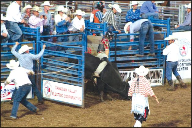 Brayden Dowdle of McLoud competes in the second round of bull riding at the IFYR on July 12. Countywide &amp; Sun/Natasha Dunagan